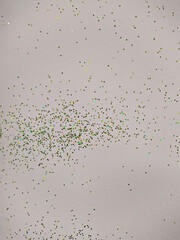 white wall with small and colored glitter
