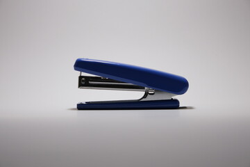 A blue stapler isolated on a white background