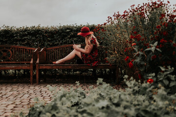 woman sitting on a bench writing in a park