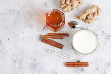 Healthy natural food for the treatment of flu and colds. Honey, milk, ginger and cinnamon to strengthen the immune system, protect against viruses, folk alternative medicine, selective focus.