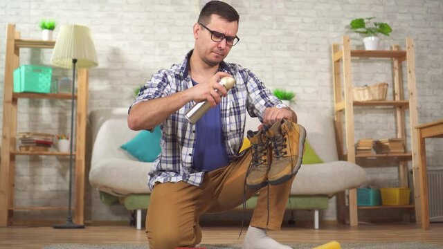 man cleans shoes from dirt with a special brush