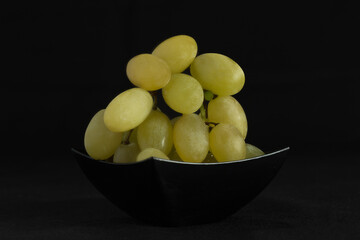 Bunch of grapes on black background