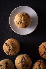muffins with chocolate chips seen from above on a dark background