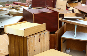 Old broken wooden furniture on waste dump site
