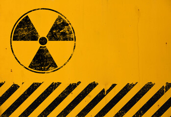 Black radioactive sign over yellow background - obrazy, fototapety, plakaty