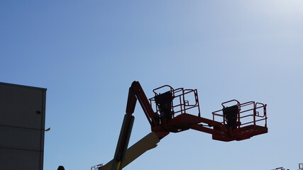 lifting crane silhouette against sky background