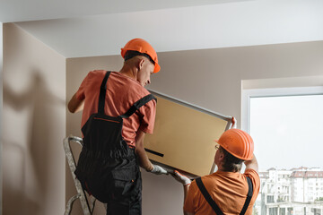 Workers are installing a split system for a air condition.