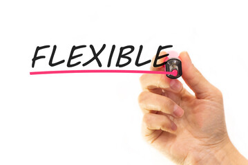 the hand writes the word flexible with a marker on a white background. business concept