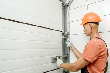 Worker is installing lift gates in the garage.