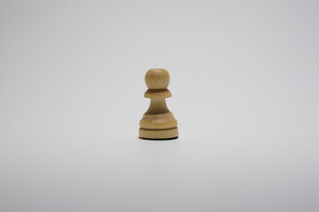White wooden chess pawn isolated on a white background.