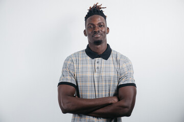 Smiling African-American millennial businessman, student isolated on a light Studio background posing, satisfied successful black man in formal suit looks at the camera laughing