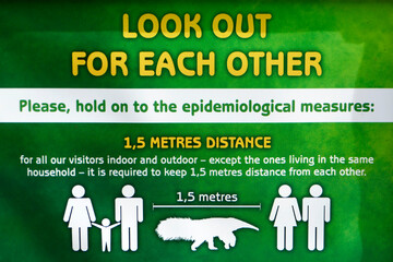 Social distance concept: creative way to explain 1,5 m distance by showing a giant anteater as measure. This sign could be seen in the Budapest Zoo in Hungary