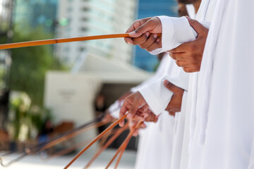 Traditional Emirati Al Ayalah male dance, UAE heritage, only hands in frame