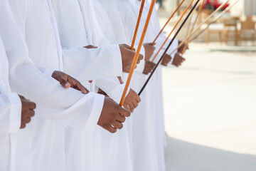 Traditional Emirati Al Ayalah male dance, UAE heritage, only hands in frame