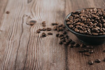 A roasted coffee beans texture  . Roasted coffee beans on wooden floor 