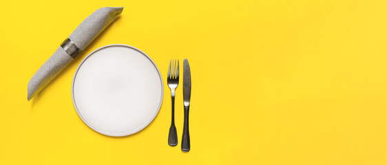 Minimalist table setting in the trendy colors 2021 - Yellow and Gray. grey plates fork knife napkin...