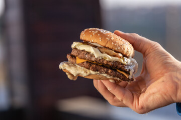 Classic burger on black background. Meat hamburger flat lay. Junk food, fast food concept.
