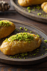 Turkish traditional sherbet dessert kalburabasti on wooden table, dough baked in syrup, handmade dessert concept