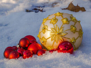 Big white and small red Christmas toy balls in the forest