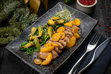 Grilled duck fillet with green salad, avocado and baked kumquat
