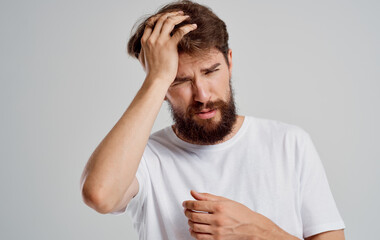 bearded man holding his head discontent health problem disorder