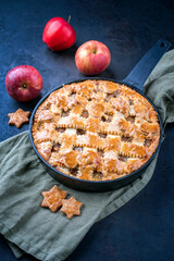 Modern style traditional apple jalousie cake served as close-up in a design backing form at a black board