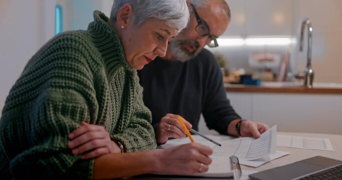Senior couple checking bills expenses together at home