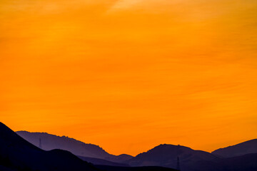 Orange Sky and sunset over Silhouetted Horizon