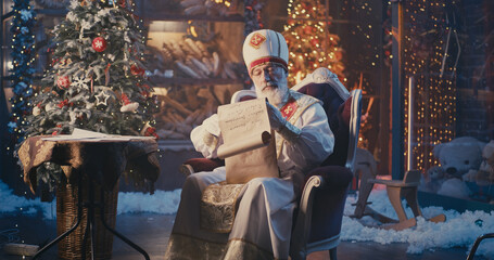 Obraz na płótnie Canvas Saint Nicholas reading letters and checking list