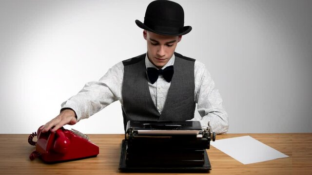 Businessman wearing bowler using typewriter