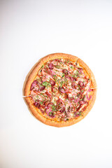 Pizza with hunting sausages, blue onions, ham and herbs isolated on white background