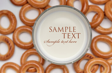 glass of milk and freshly baked bagels isolated on a white background, top view