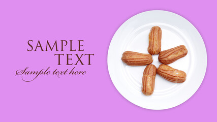 Home made cake eclairs. Traditional eclairs, profiteroles classic, eclairs french. The choux buns on a serving plate