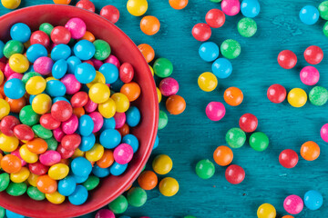 Colorful Confetti candy in bowl with blue background.