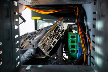 technician worker installing gpu graphics card to a desktop pc case. looking inside pc case....
