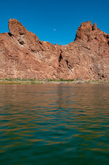 Fototapeta na wymiar moon over red mountains in the desert lake havasu 