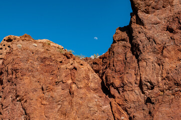 Fototapeta premium moon over red mountains in the desert
