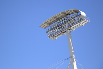 Sports stadium lights against blue sky