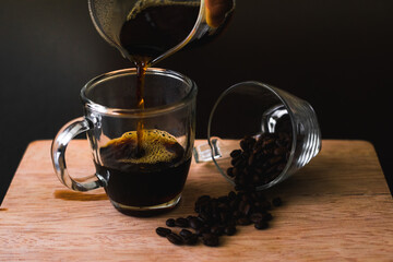 cup of coffee and coffee grain on black background