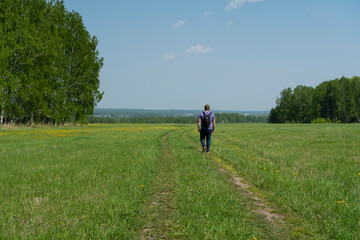 A man walks on a rural road