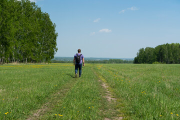 Fototapeta premium A man walks on a rural road