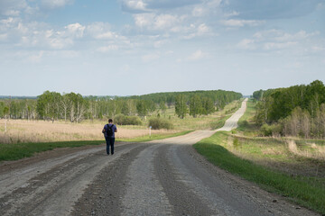 Obraz premium A man walks on a rural road