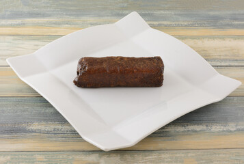 Japanese fugashi fried wheat snack coated with brown sugar on white snack plate on table