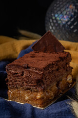 Sofia dessert with layers of chocolate mousse and caramelized peanuts covered with cocoa powder