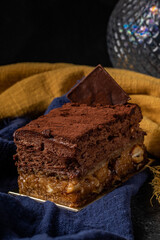 Sofia dessert with layers of chocolate mousse and caramelized peanuts covered with cocoa powder