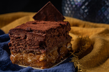 Sofia dessert with layers of chocolate mousse and caramelized peanuts covered with cocoa powder
