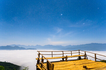 Starry night sky with bamboo terrace in front of mountains at Gloselo, Khun Yuam District, Mae Hong...