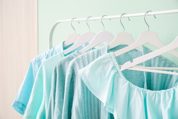 Rack with clothes near color wall