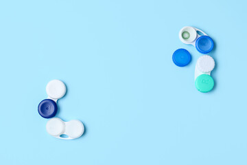 Containers with contact lenses on color background