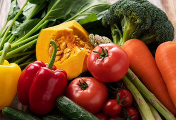 Many kinds of vegetables placed on a wooden background